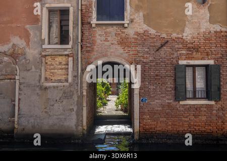 Interior Yard Along a Canal With Entrance Right on the Water in Venice Italy Stock Photo