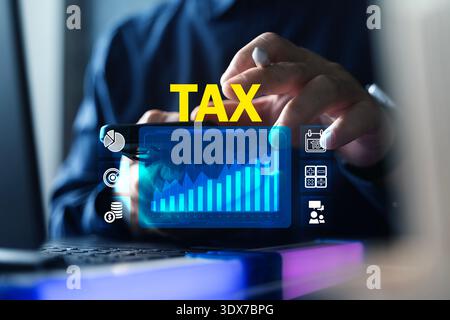 Close-up of business professional using smartphone and laptop with TAX text and digital chart interface, representing tax planning, online filing, acc Stock Photo