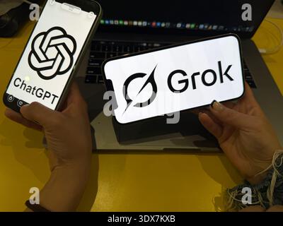 ChatGPT and Grok AI logos displayed on smartphone screens. This editorial image illustrates the competition between OpenAI and xAI technology in 2026. Stock Photo