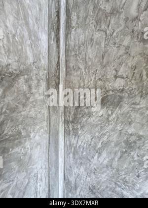 Rough gray concrete wall with raw cement texture. An industrial modern background with vertical line, creating simple abstract and solid feeling Stock Photo