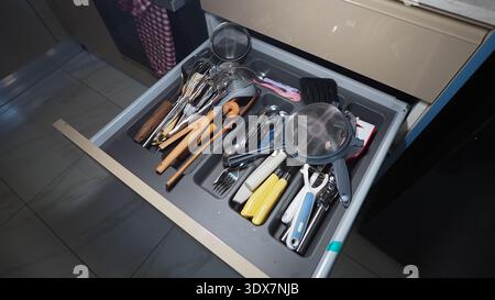 Kitchen drawer with various cooking tools and utensils Stock Photo