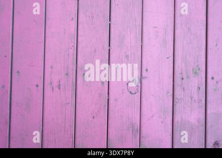 Wooden planks painted in pink color on a flat surface Stock Photo