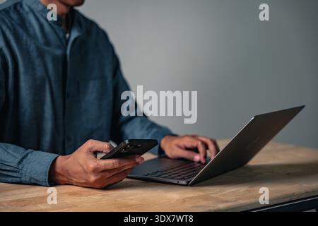 The hand of a man shows a business pose, this focused gesture and sign of work has him posing for the camera, a professional pose while using a laptop Stock Photo