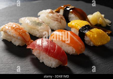 Assorted traditional Japanese nigiri sushi set on a dark slate plate Stock Photo
