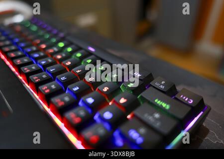 Vibrant, colorful gaming keyboard illuminated with modern rgb backlit technology. This computer hardware accessory glows in dark, creating an exciting Stock Photo