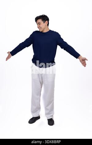 Young man spreading hands in a welcoming gesture Stock Photo