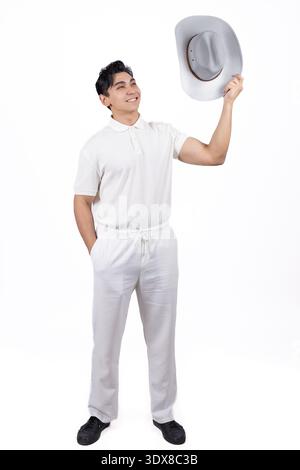 Man in white outfit holding a hat and smiling Stock Photo
