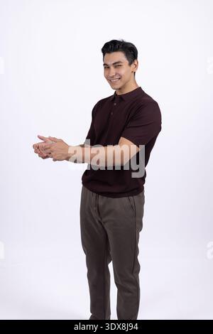 Young man pointing to the side with his hand Stock Photo