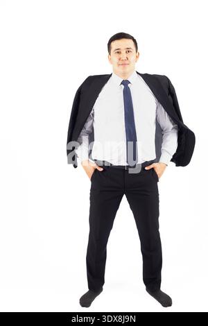 Confident businessman standing with hands in pockets Stock Photo