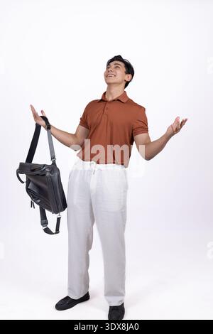 Young man holding a black bag or backpack Stock Photo