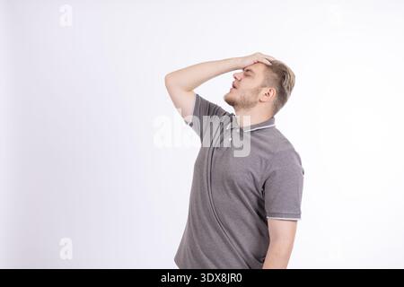 Young man touching his head in frustration Stock Photo