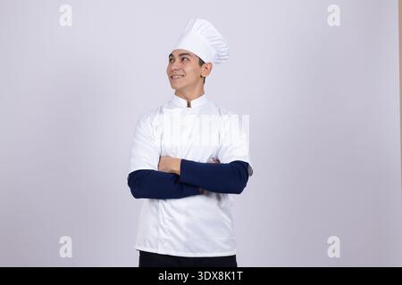 Chef in white uniform looking thoughtful Stock Photo