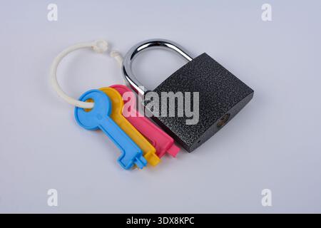 Lock and Keys .Closeup of padlock with keys.Metallic padlock with three keys in keyhole . Stock Photo