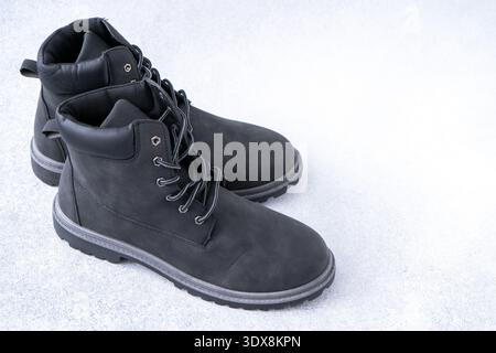 Black Suede Work Boots. Footwear shoes on gray background. Stock Photo