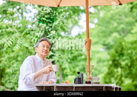 Senior man drinking coffee on the terrace Stock Photo