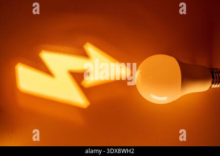 Glowing yellow arrows and sphere on dark background Stock Photo
