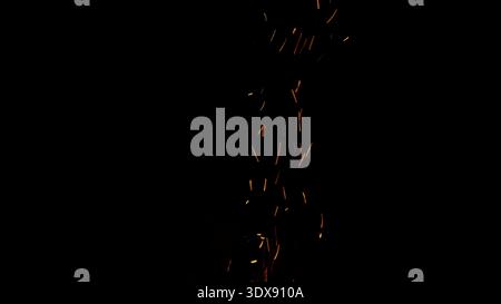 sparks and embers from campfire flying over black background Stock Photo