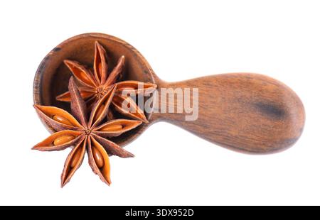 Star anise isolated on white background. Anise stars or badian spice in wooden spoon. Clipping path. Stock Photo