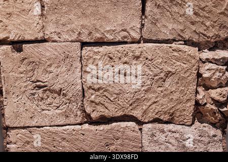 Rough stone wall surface showing ancient masonry texture for architectural backgrounds, strong construction, and solid foundations Stock Photo
