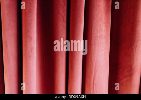 Red velvet stage curtains creating a rich, textured background, representing drama, elegance, and performances Stock Photo