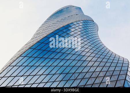 Modern glass facade featuring abstract curves and geometric patterns Stock Photo
