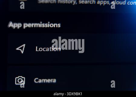 Smartphone or computer app permissions settings menu displaying location and camera access options, digital privacy and data security management conce Stock Photo