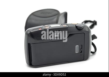 Rear view of a vintage black 35mm compact analog film camera featuring an LCD screen and viewfinder, with original case and strap on a white backgroun Stock Photo