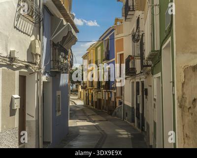 Quaint old narrow street with colorful houses in Villajoyosa town, Spain Stock Photo