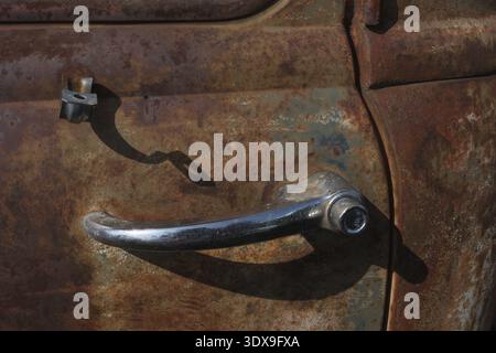 Close-up of a chrome door handle of an old rusty car Stock Photo