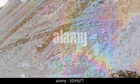 Oil spilled on melting snow. Stock Photo