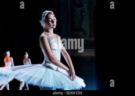 ballerina performing on stage in a white tutu. Graceful ballet dance Stock Photo