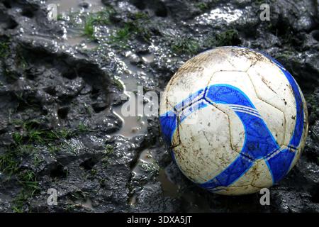 Football in the mud, suitable for a sports illustration Stock Photo