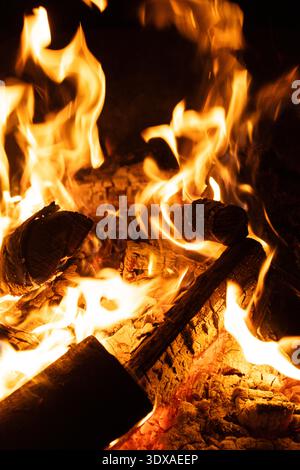 Close-up of Logs Burning with Intense Yellow and Orange Flames. Stock Photo