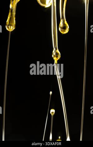 Abstract oil splashes and drips isolated on black for luxury design Stock Photo