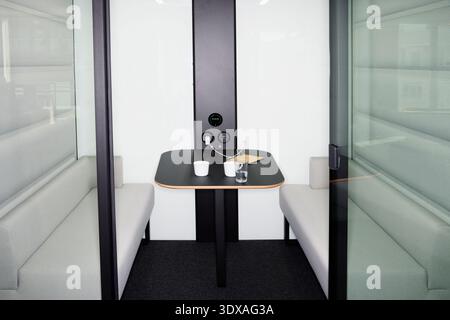 Modern interior of empty sofa with table in office booth Stock Photo