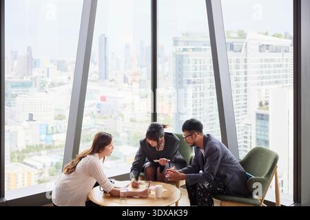 Team of corporate professionals discussing business ideas at office Stock Photo