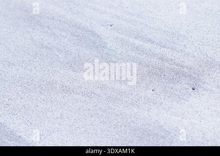 Wind patterns on grey sand surface creating textured background in natural environment Stock Photo