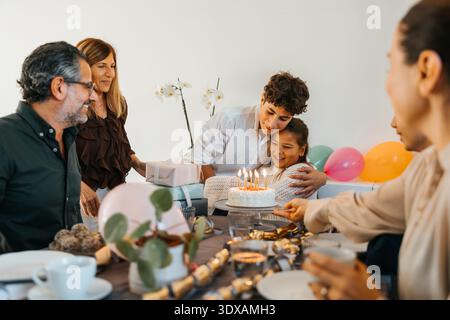Brother embracing sister while celebrating birthday at home Stock Photo