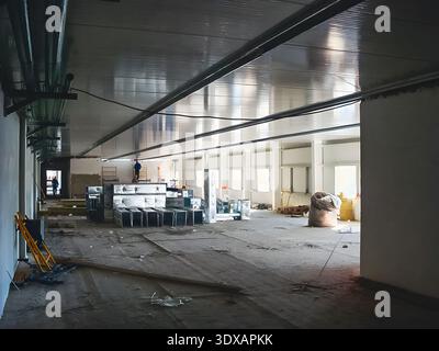 This image shows the interior of a building during the construction phase, with workers visible in the background Stock Photo