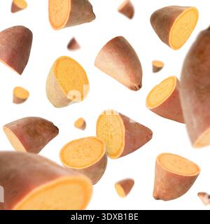 Sweet potato pieces falling against white background Stock Photo