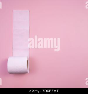 A roll of white toilet paper on a pink background. The roll is partially unrolled, showcasing the soft texture of the paper. Stock Photo