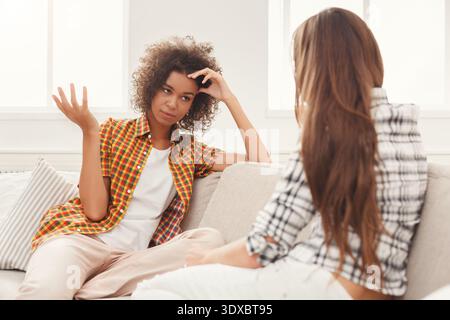 Conversation Between Two Women in a Living Room Setting During the Daytime Stock Photo