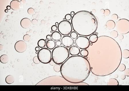 Oil and water creating an abstract macro background texture with round shapes Stock Photo