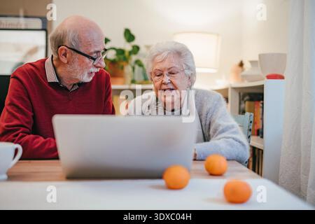 Old people having problem with laptop. Stock Photo