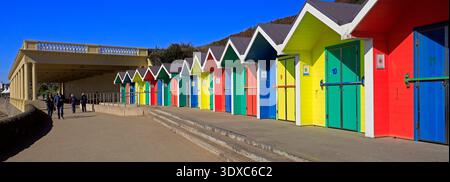 Multi coloured painted wooden beach huts and pavilion at Barry Island seaside resort, South Wales, UK Stock Photo