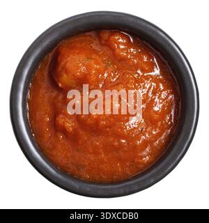 Black ceramic bowl containing red tomato sauce likely. Stock Photo