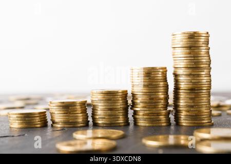 Collections of Coins Stacked in Different Heights Showing Growth in Savings Over Time Stock Photo