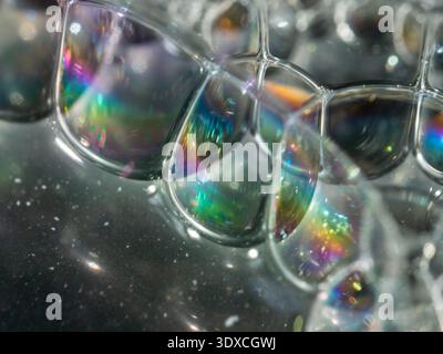 Irregular bubbles gleam with rainbow hues Stock Photo