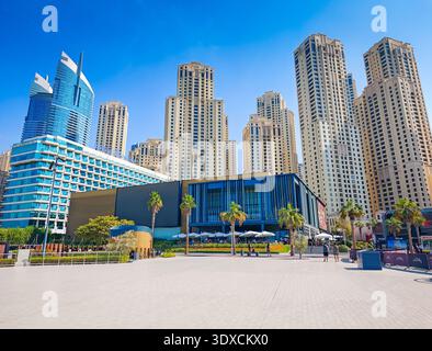 12 03 2025 - Dubai, United Arab Emirates. Dubai JBR Beach on a bright sunny day, people enjoying sand, sea, and clear skies. Dubai vacation background Stock Photo