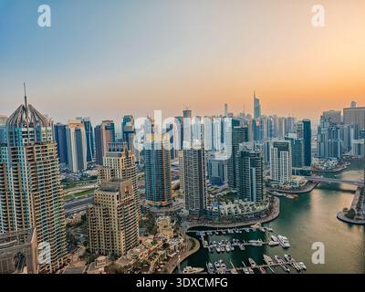 12 30 2025 - Dubai, UAE. Aerial view of Dubai Marina at sunset. Drone view of Dubai skyline, urban waterfront. Dubai panoramic background Stock Photo